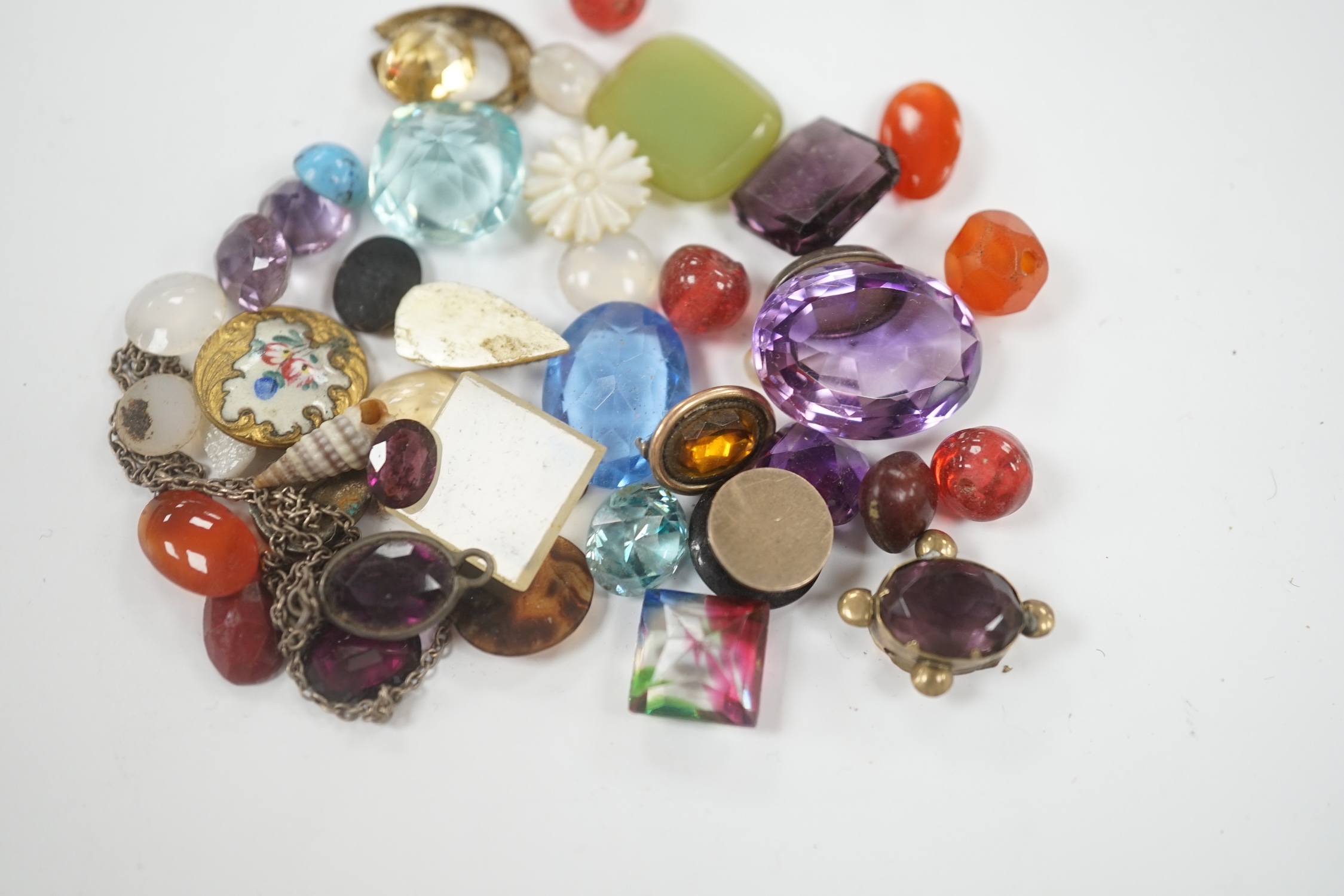 A small quantity of loose cut and cabochon gemstones including carnelian, white opal etc.